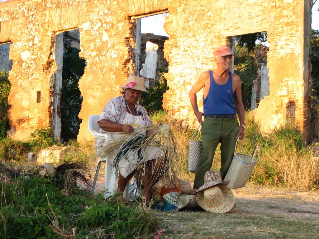 This couple came nightly to watch the sun set on the beach, while the wife weaved hats and sold them to tourists and locals. 