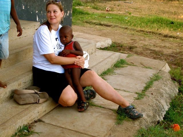 Girl holding child in orphange