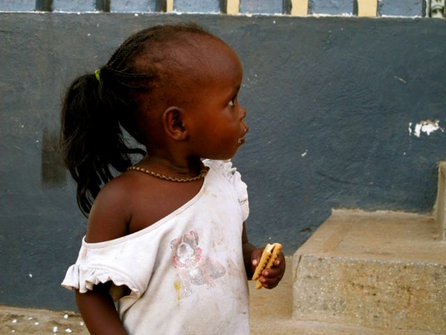 Girl in Orphanage Eating Cookie